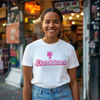 Thumbnail for Beautiful smiling Dominican girl wearing a white t-shirt with pink 'Dominicana' design, featuring a Barbie silhouette but of a woman's head with hair curlers, standing in front of a colorful bodega in a Dominican-American neighborhood.