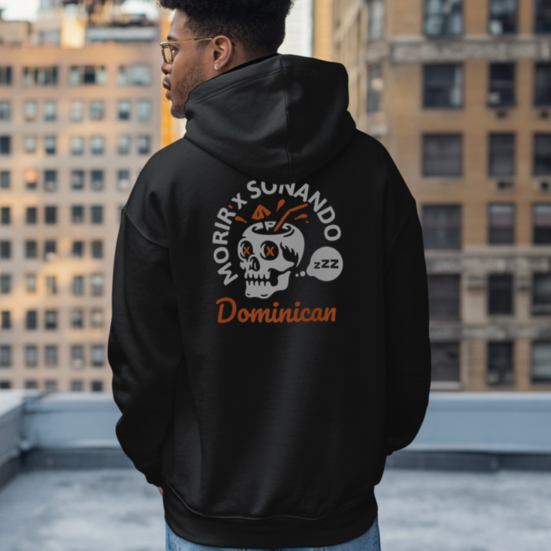 Back of a Dominican wearing an oversized Gildan 18500 graphic hoodie with a skull drink and the words "Morir Soñando Dominican" on the front