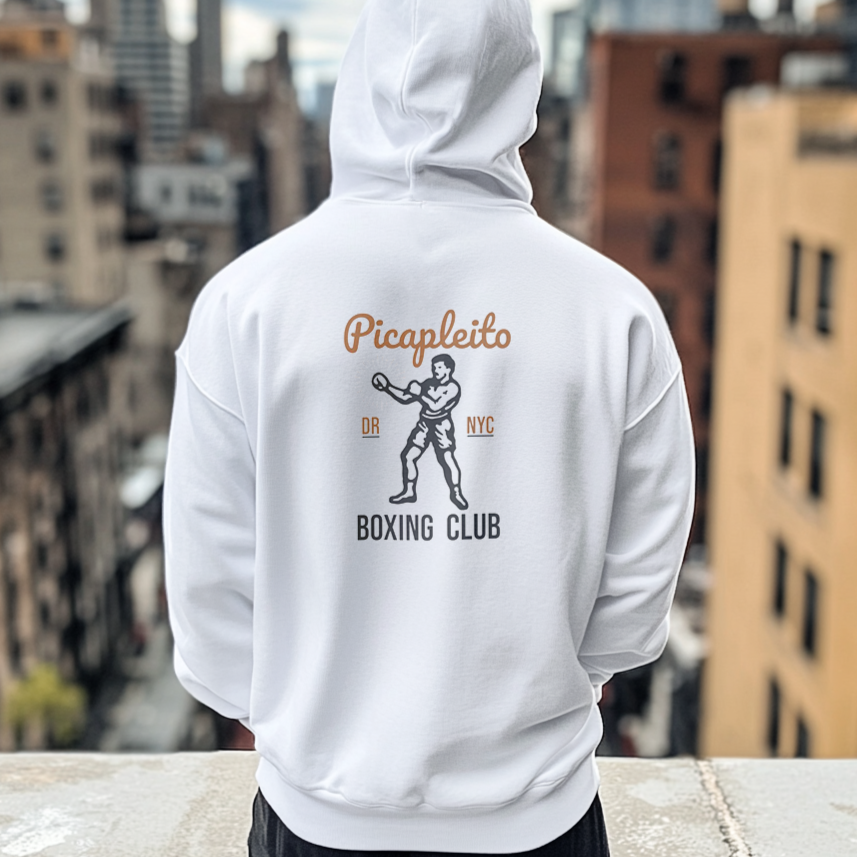 The back of a man wearing a Gildan 18000 graphic Hoodie with a vintage image of a guy in boxing gloves with the words "Picapleito DR NYC Boxing Club"