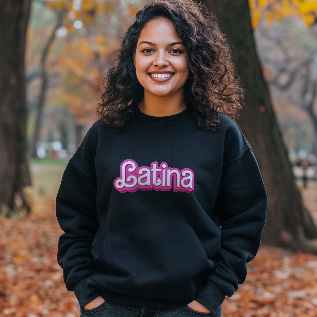 Beautiful Dominican girl smiling wearing an oversized Gildan 18000 graphic crew neck sweatshirt with the words "Latina" on the front in a Barbie font