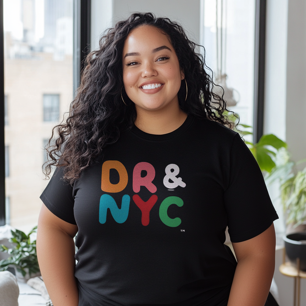 Beautiful Dominican plus sized girl smiling wearing an oversized Bella Canvas 3001 graphic tshirt with the words "DR & NYC" on the front