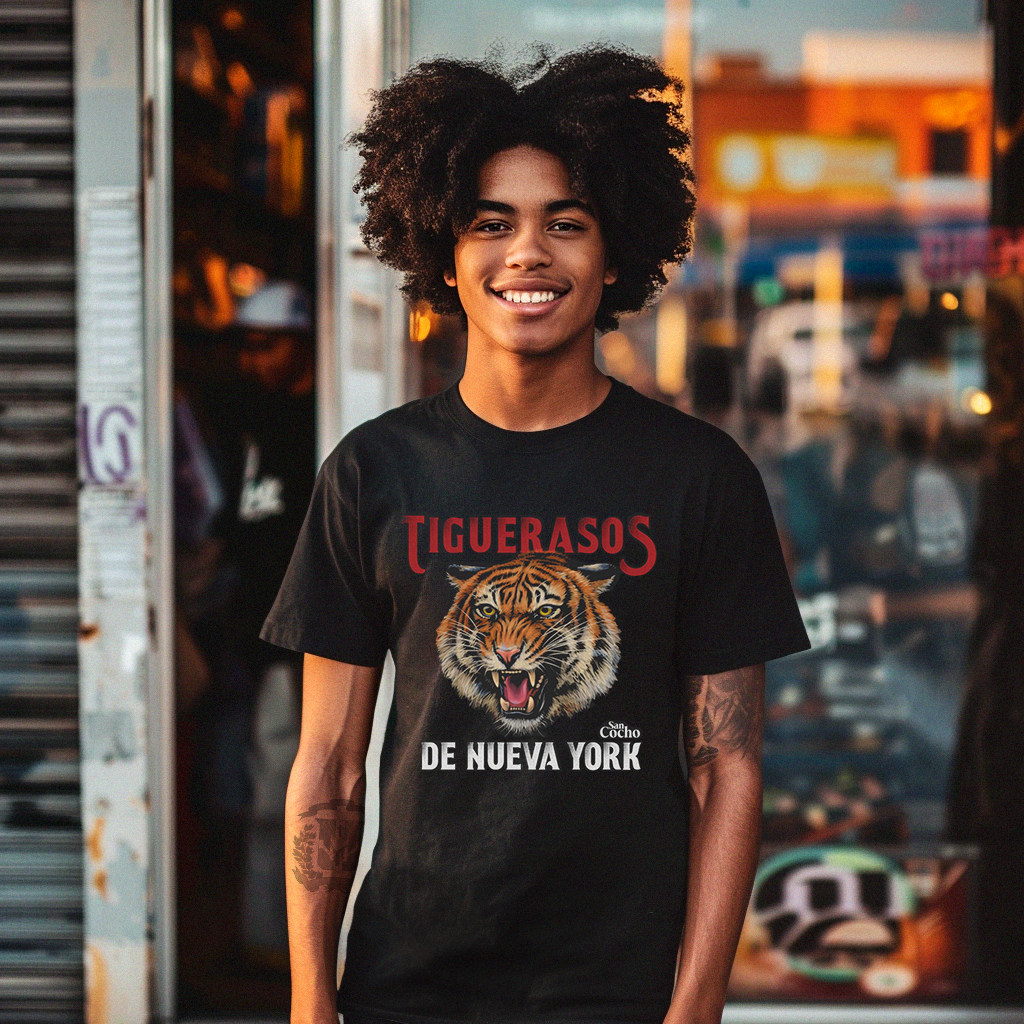 Good looking Dominican kid wearing a Bella Canvas 3001 graphic tshirt with a realistic Tiger and the words "Tiguerasos de Nueva York - SanCocho" on the front