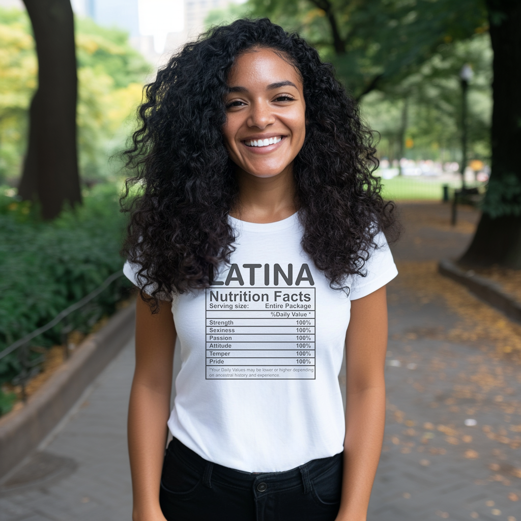 Pretty Dominican girl smiling wearing an oversized Bella Canvas 3001 graphic tshirt with the words "Latina Nutrition Facts" followed by an ingredients label on the front