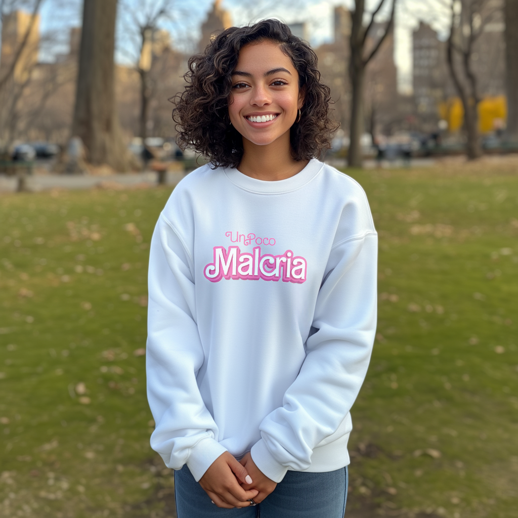 Pretty Dominican girl smiling wearing an oversized Gildan 18000 graphic crew neck sweatshirt with the words "Un Poco Malcria" on the front in a Barbie font